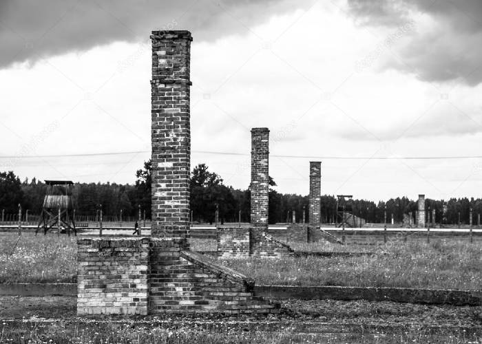 Brick chimneys left in ruins of accomodation buildings in Birkenau concentration camp. Poland