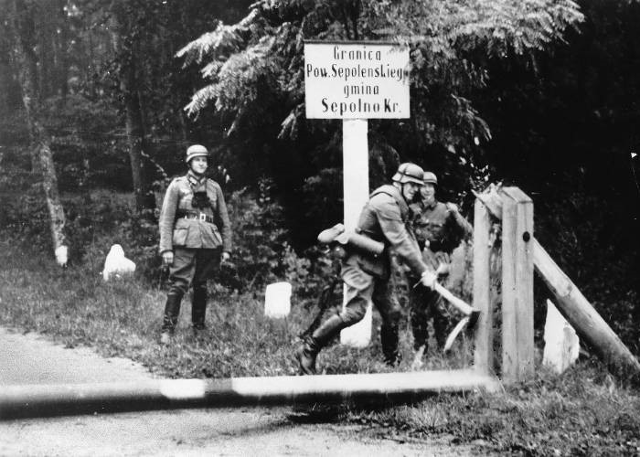 German soldiers breaking down a barricade at the Polish border at the outbreak of World War II, 1939.